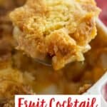 dump cake in a spoon over casserole dish with text reading fruit cocktail dump cake