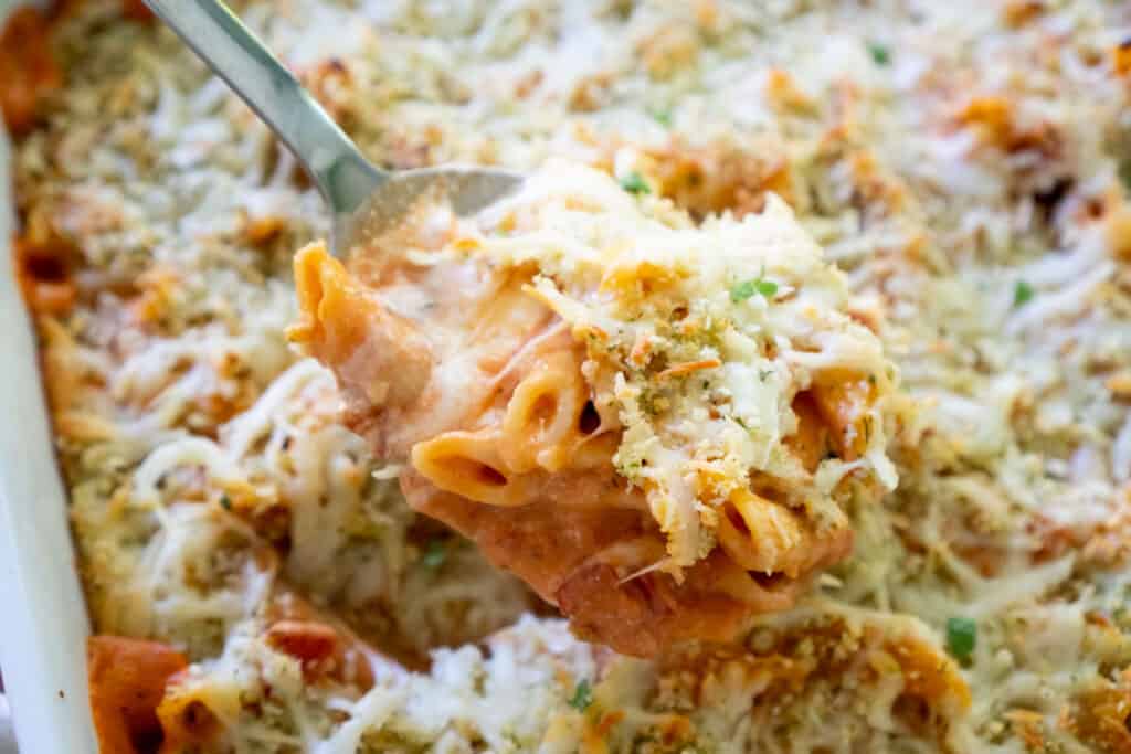 copycat olive garden 5 cheese ziti al forno in serving spoon over white baking dish