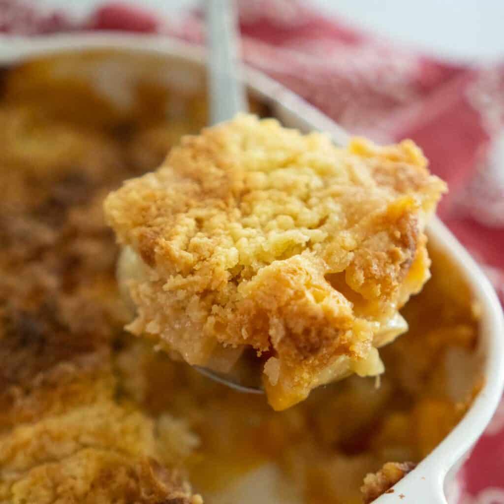 dump cake in a spoon over casserole dish