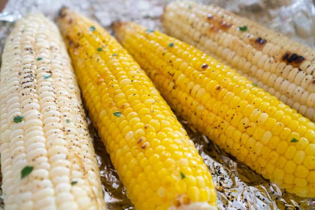 four cobs of corn after grilling in foil