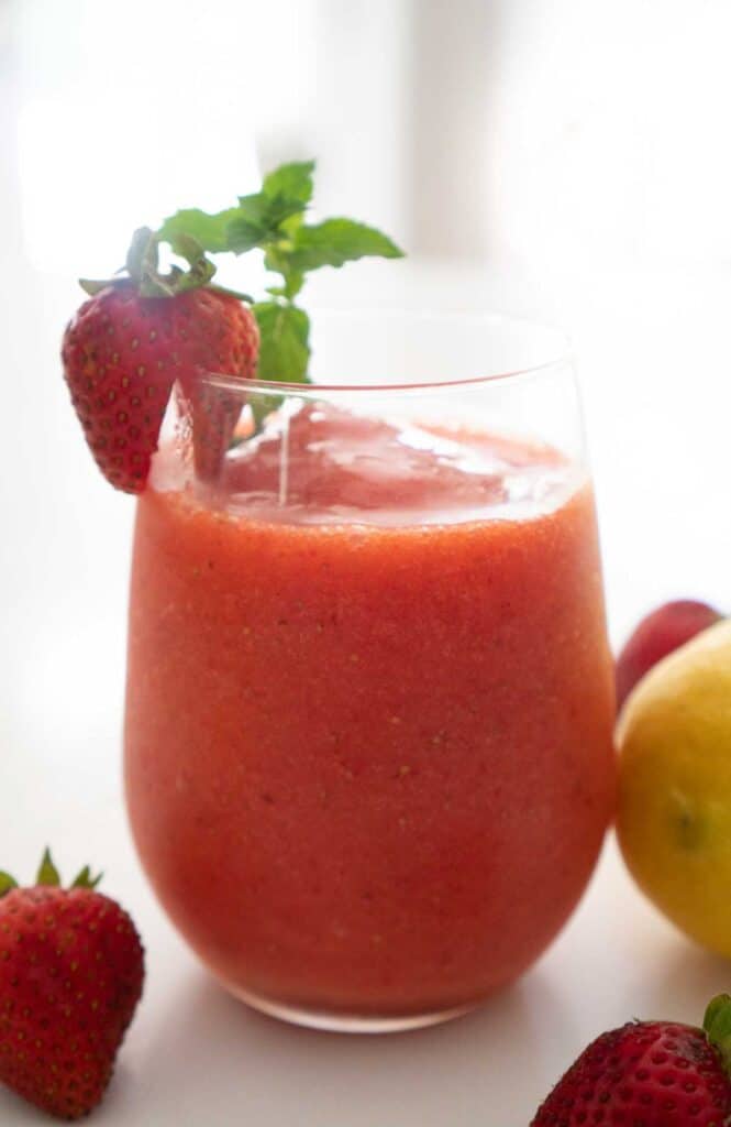 frozen strawberry lemonade with strawberry and mint garnish