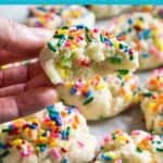 hand holding funfetti cookie with bite taken out with more cookies in background and text reading funfetti cake mix cookies