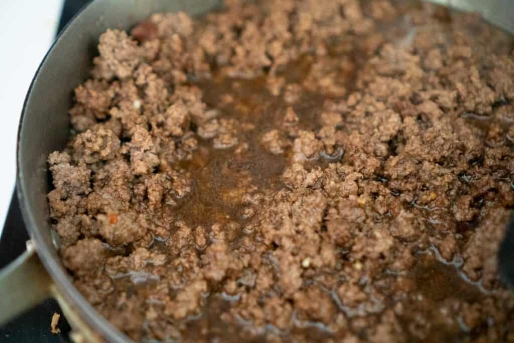 ground beef cooking in pan with Mongolian sauce