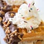 waffle ice cream sandwich with sprinkles and whipped cream