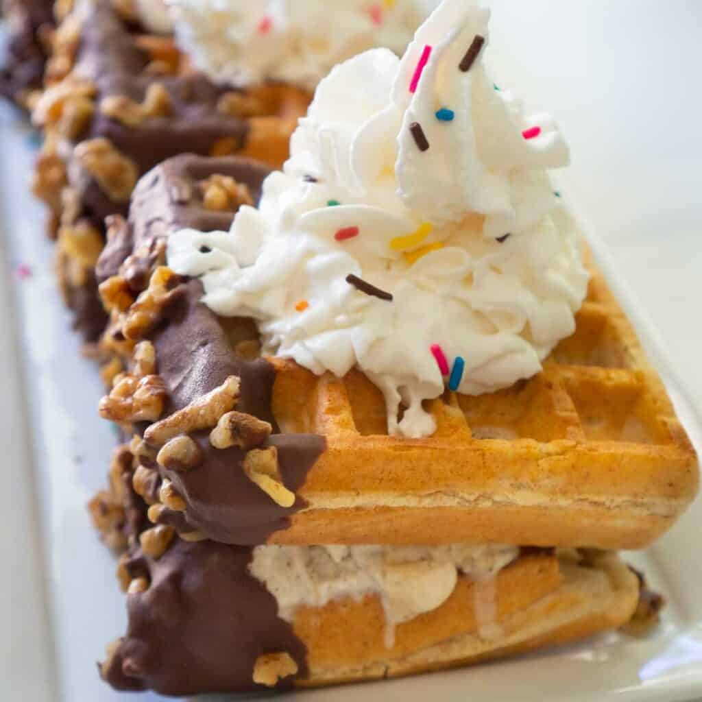 waffle ice cream sandwich with sprinkles and whipped cream