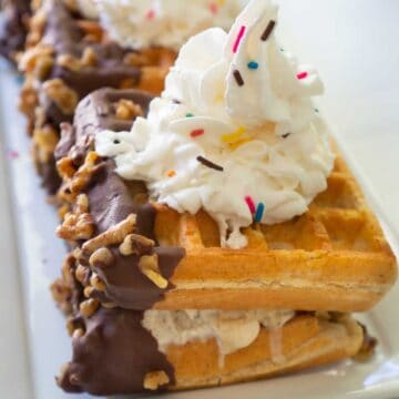 waffle ice cream sandwich with sprinkles and whipped cream