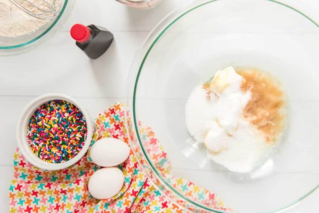 ingredients for funfetti cupcakes with glass bowl