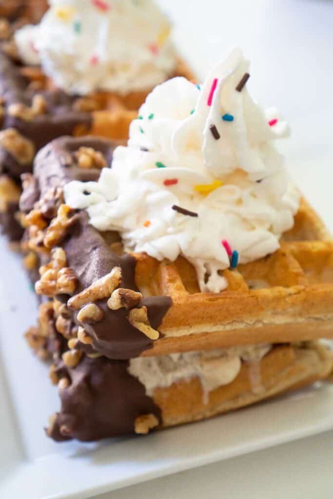 waffle ice cream sandwich with sprinkles and whipped cream