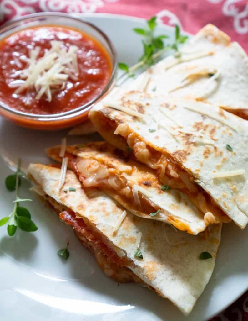 close photo of pizza quesadilla with marinara dipping sauce