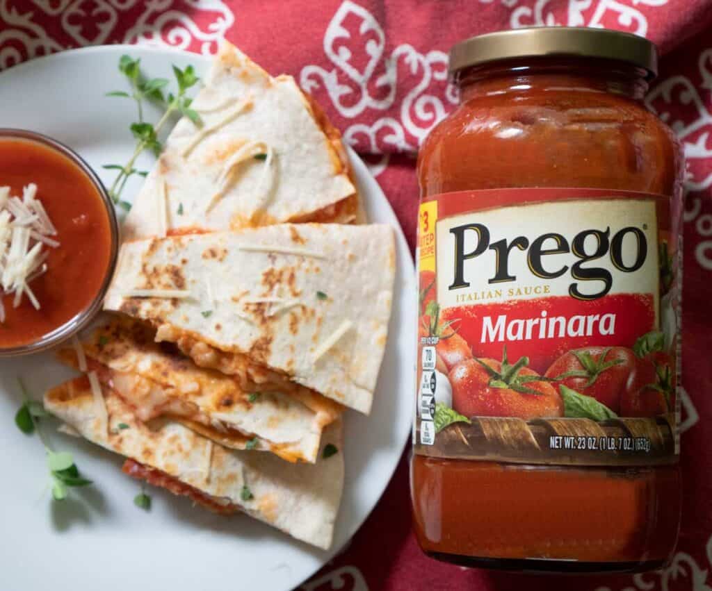 pizza quesadilla on white plate with bottle of prego spaghetti sauce