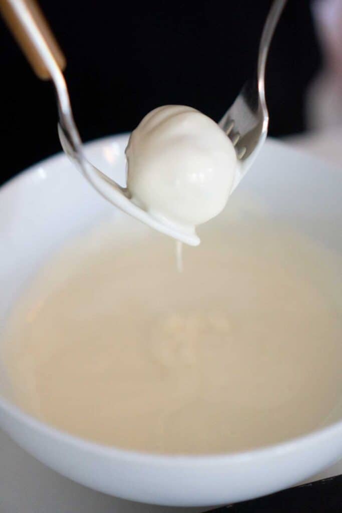 two forks holding truffle over bowl