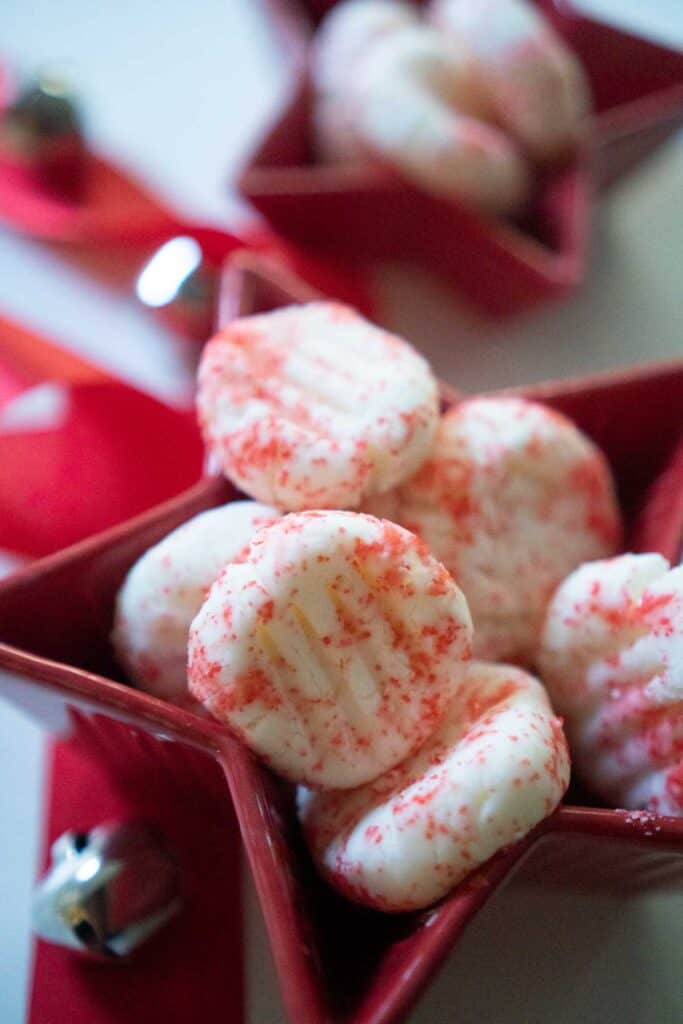 cream cheese mints with red sprinkles in red star-shaped candy dish