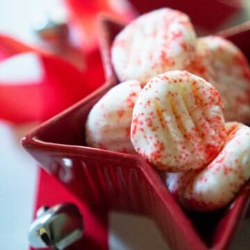 cream cheese mints with red sprinkles in red star-shaped candy dish
