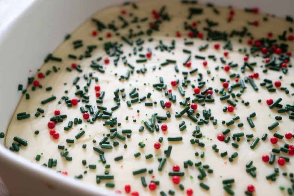 white chocolate fudge with Christmas sprinkles in white dish