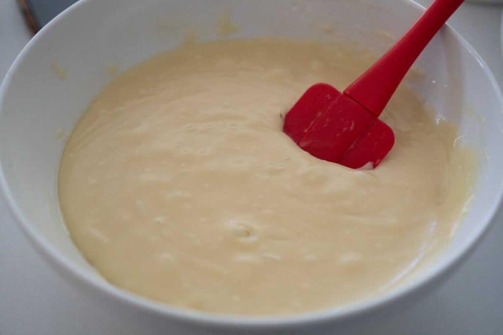 mixing white chocolate fudge in white bowl