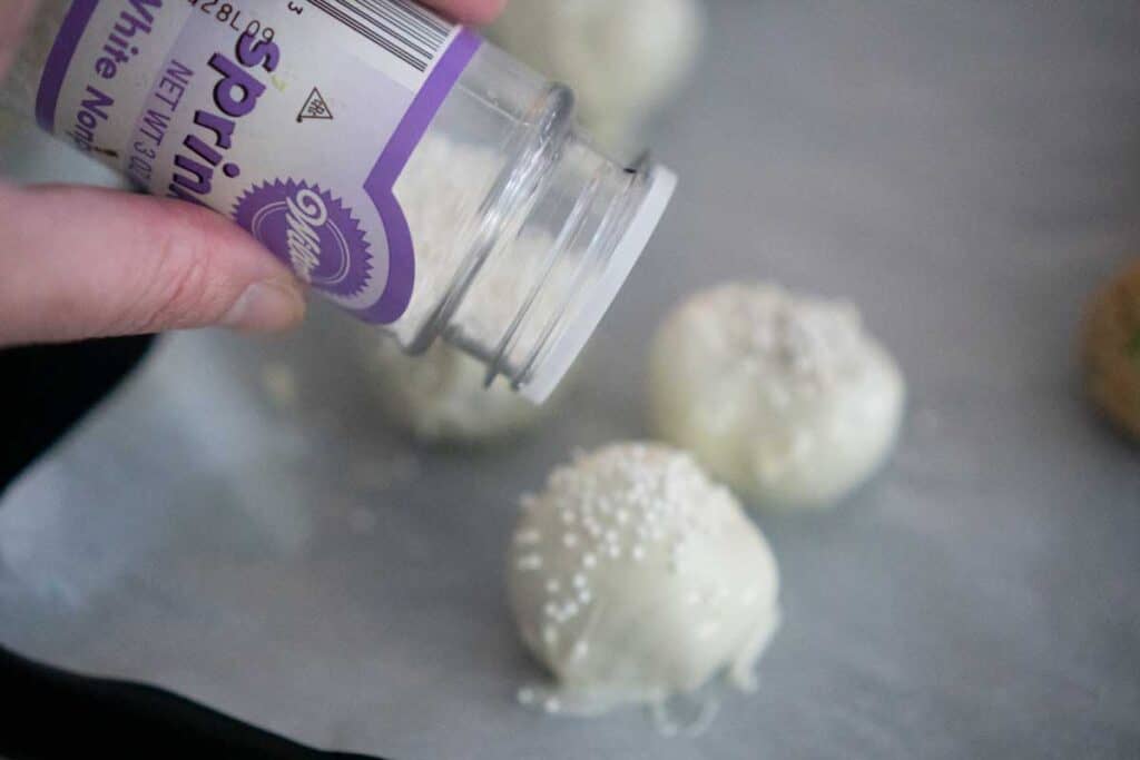 adding white prinkles to white chocolate truffle