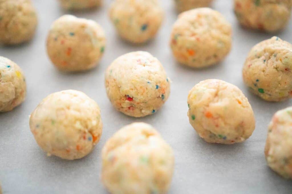 sugar cookie truffles before coating on parchment paper