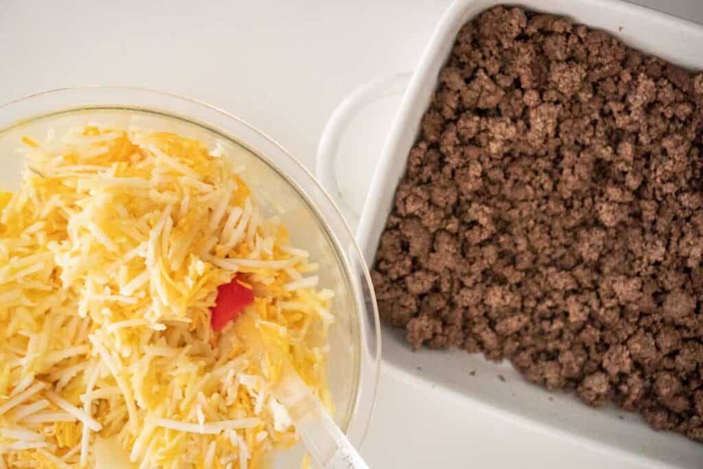 bowl of hash browns and baking dish of meat