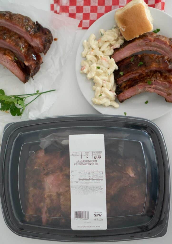 overhead view of container with ribs by plate of ribs with pasta salad