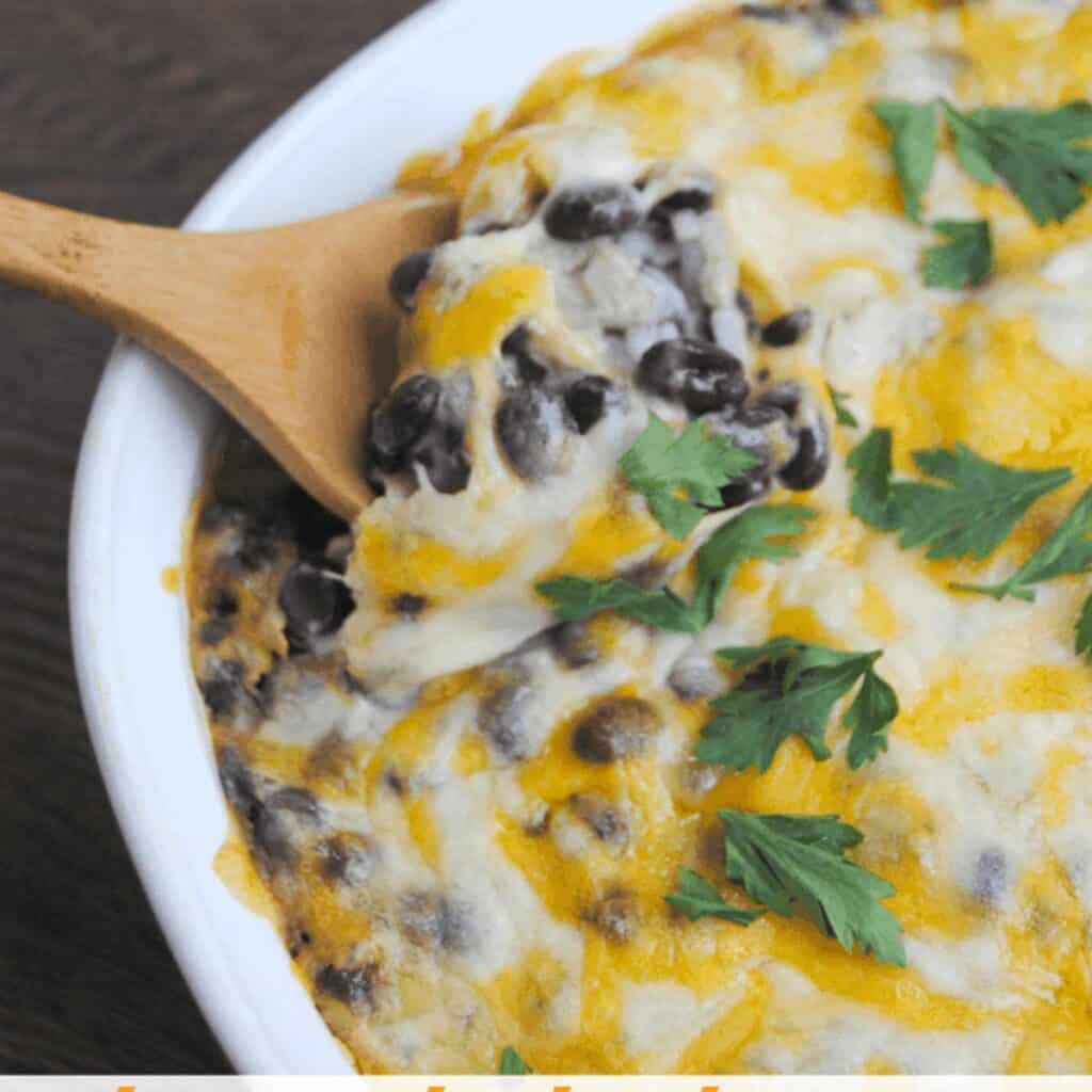 spoon with cheesy baked black beans and rice