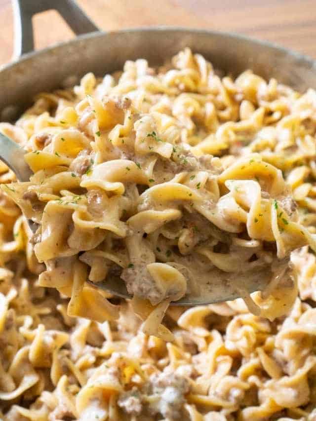 sausage pasta in spoon over pan