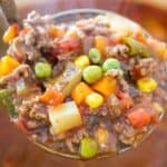 ladle of ground beef vegetable soup