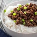 bowl of rice topped with Korean ground beef and chopped green onion