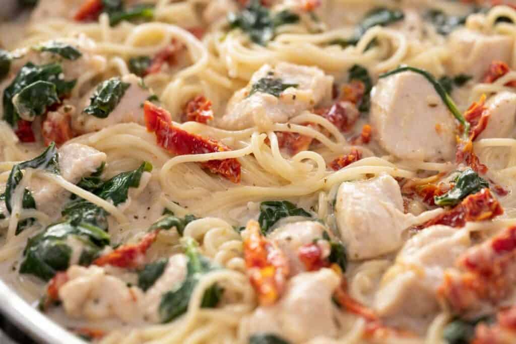 close up of creamy Tuscan chicken pasta