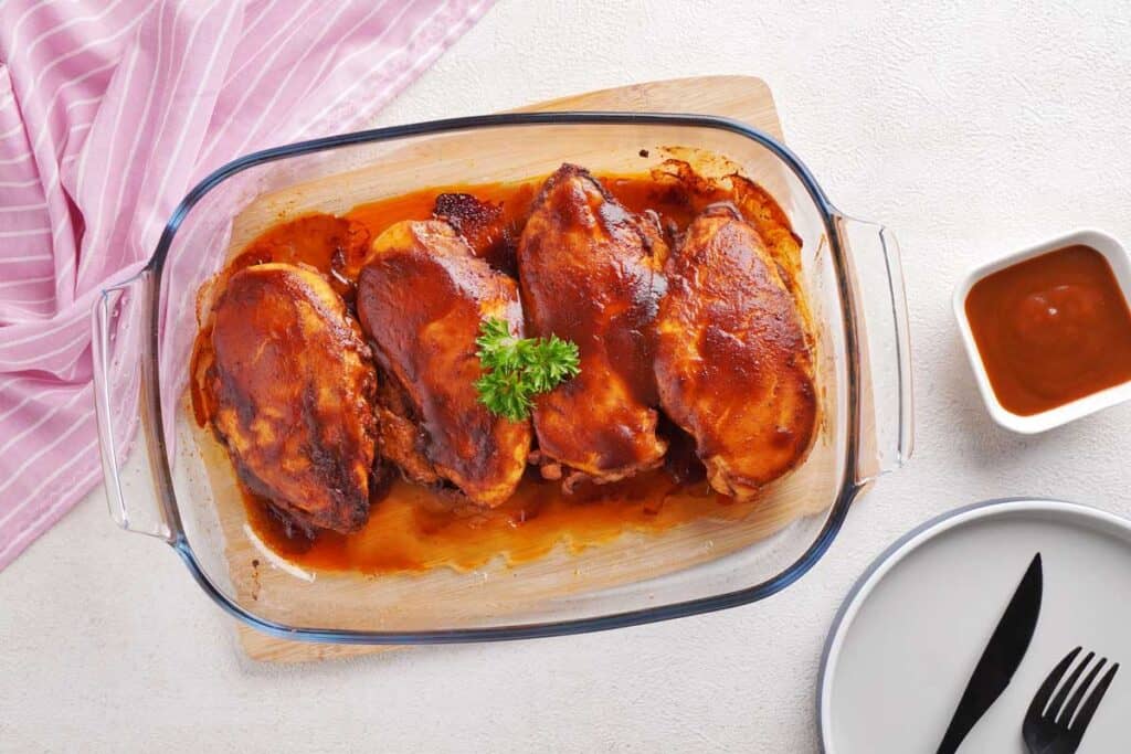 baked barbecue chicken breasts in glass baking dish