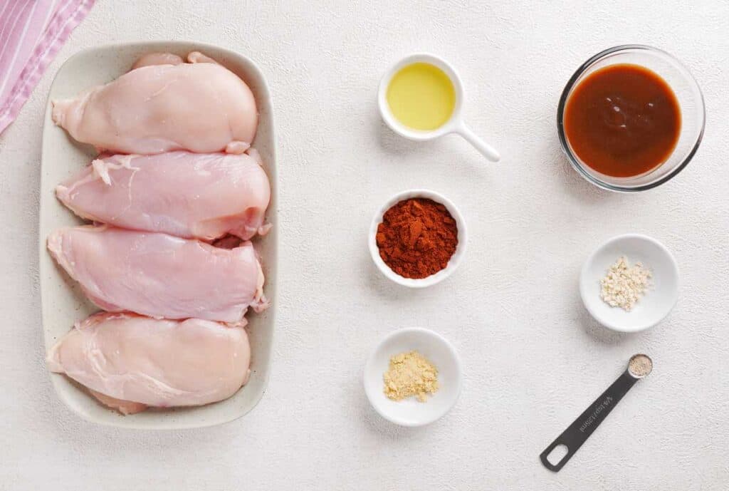 baked barbecue chicken breast ingredients on white counter