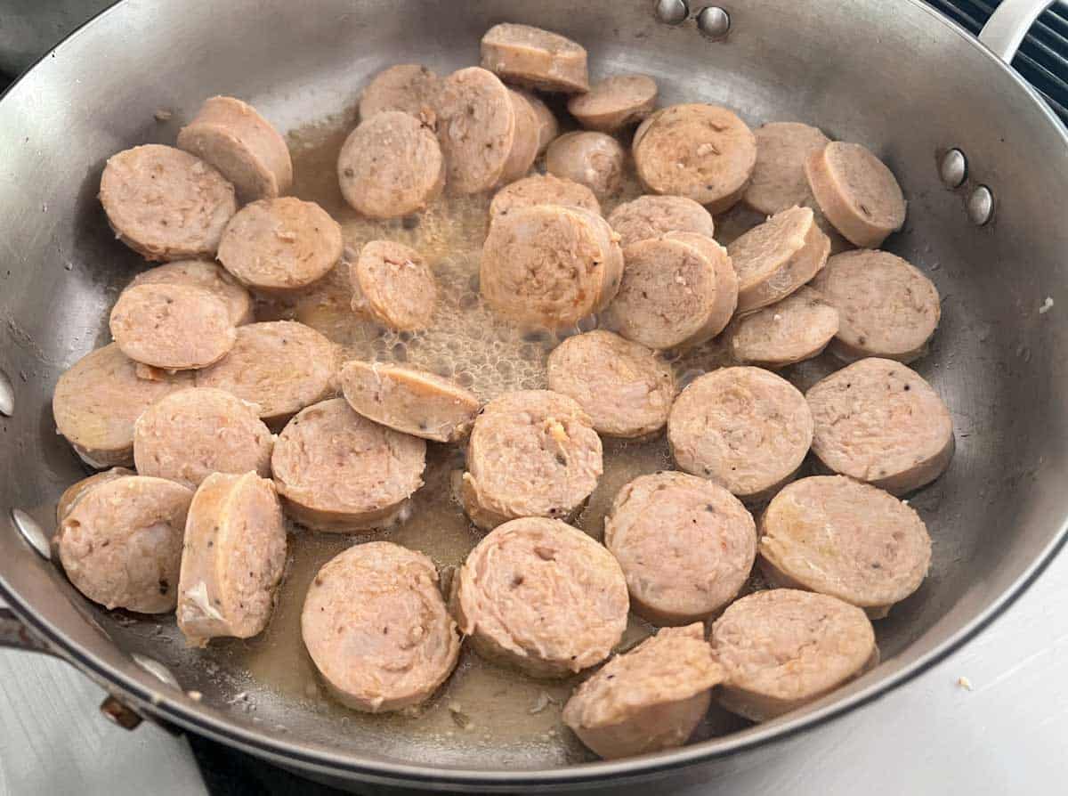 sliced chicken sausage in skillet