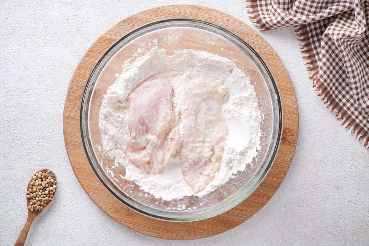 breading chicken breasts in flour mixture