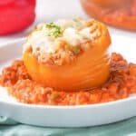 orange stuffed bell pepper on white plate