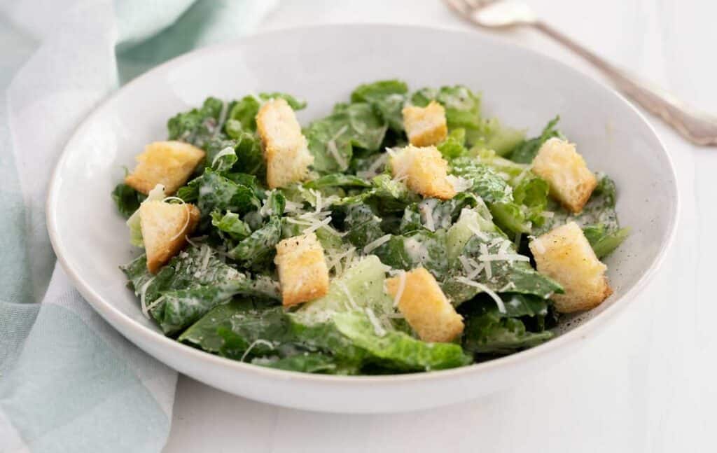 Caesar salad in white bowl