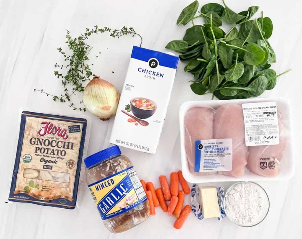 ingredients for chicken gnocchi soup on marble counter