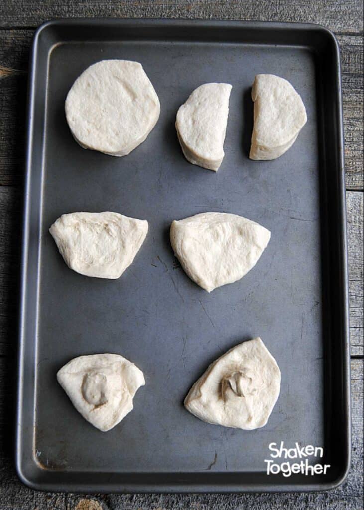 premade biscuits on cookie sheet cut in half