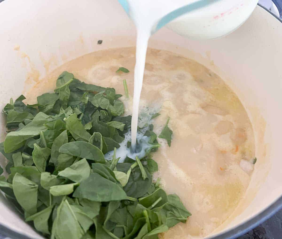 pouring milk into pot for chicken gnocchi soup