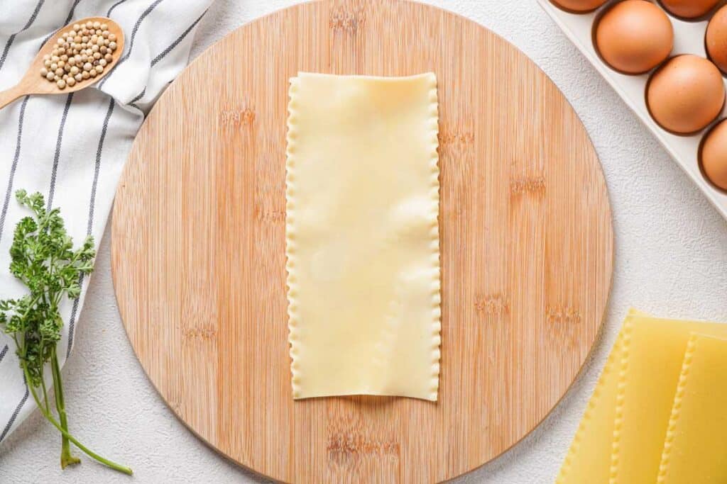 lasagna noodle on round cutting board