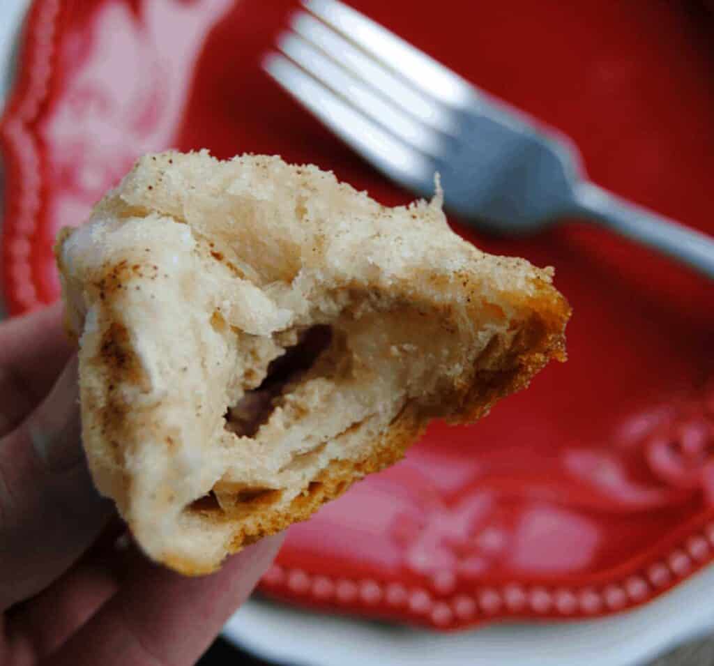 hand holding monkey bread bite town in half