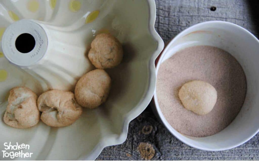 rolling biscuit dough in cinnamon sugar