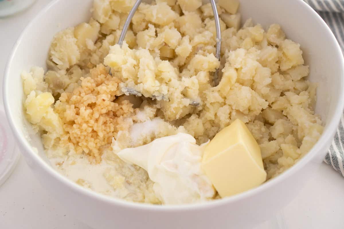mashed potato ingredients in large white bowl