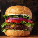 cheese burger with tomato, onion, and lettuce