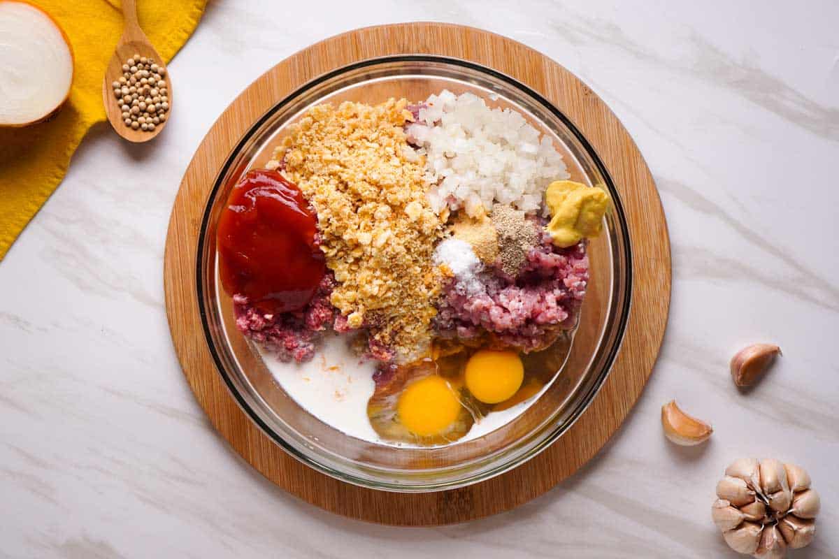 meatloaf ingredients in glass bowl before mixing