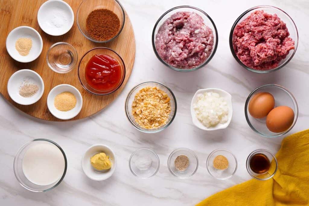 overhead view of meatloaf ingredients on marble countertop