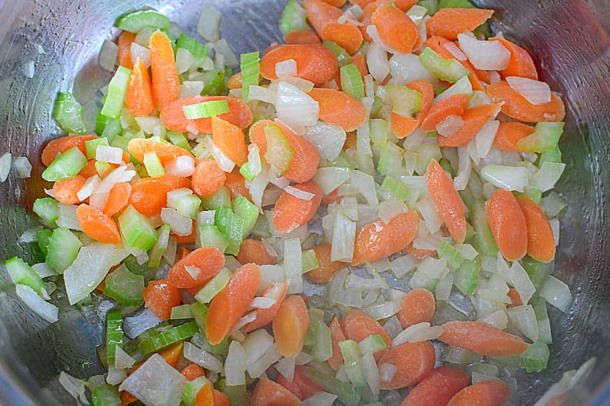 chopped celery, onion, and carrots sautéing in pot