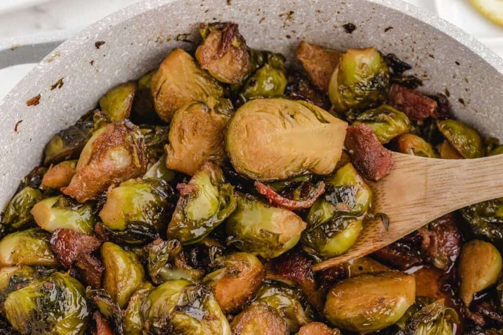 close up of brown sugar brussels sprouts in dutch oven
