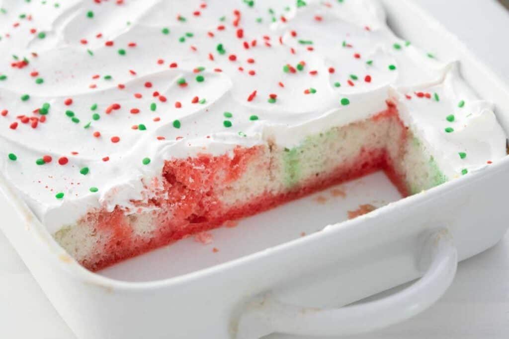 Christmas poke cake with three pieces removed