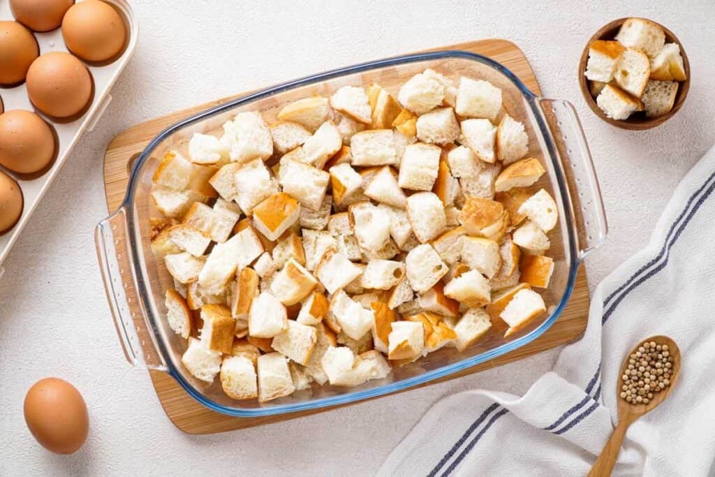 torn up bagels in casserole dish