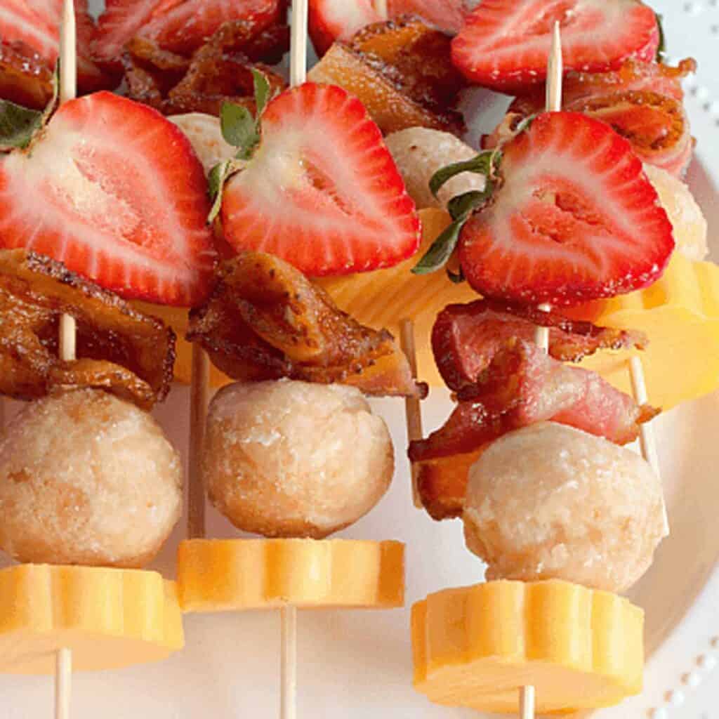 close up of berry brunch kabobs with cheese and bacon
