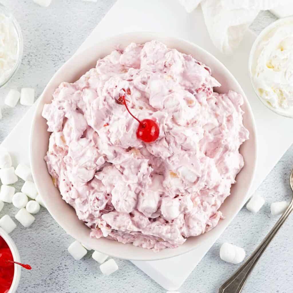 overhead view of cherry fluff in bowl topped with cherry